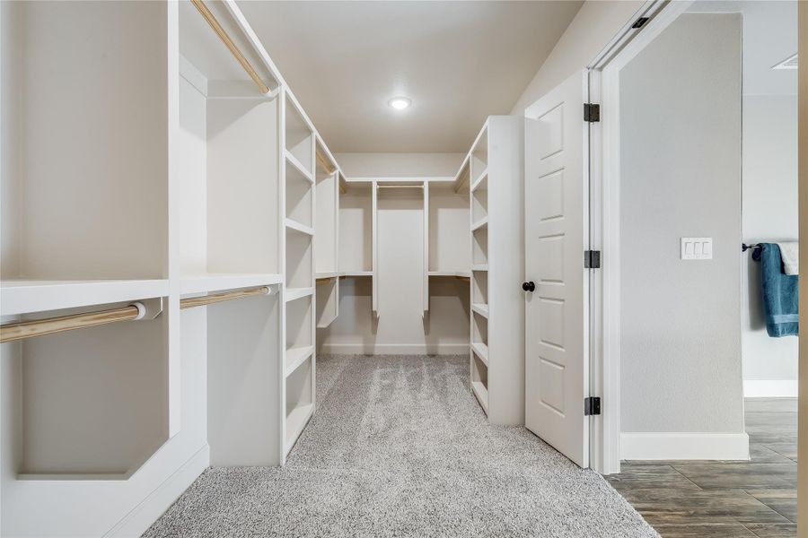 Primary Bedroom Walk in closet. Attached to the Laundry room. Primary Bedroom Walk in closet. Attached to the Laundry room.