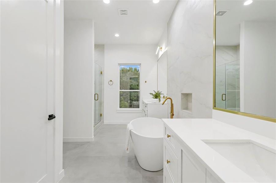 Bathroom featuring vanity, tile patterned flooring, and separate shower and tub