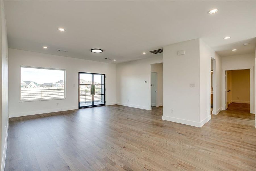 Empty room featuring light wood-type flooring and recessed lighting Empty room featuring light wood-type flooring and recessed lighting