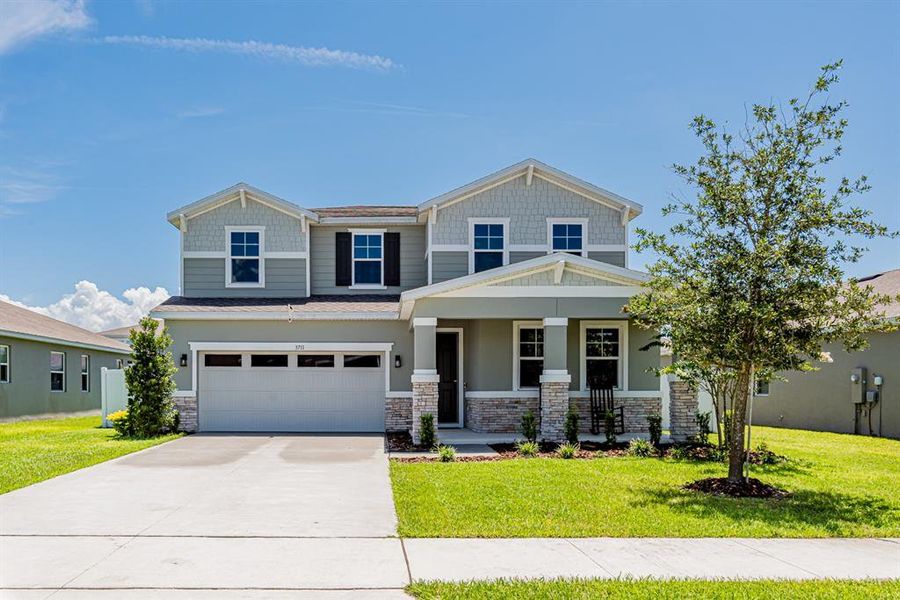 Front exterior of a new home in Seasons at Lakeside Forest, Tavares, FL, highlighting curb appeal (Image 1).