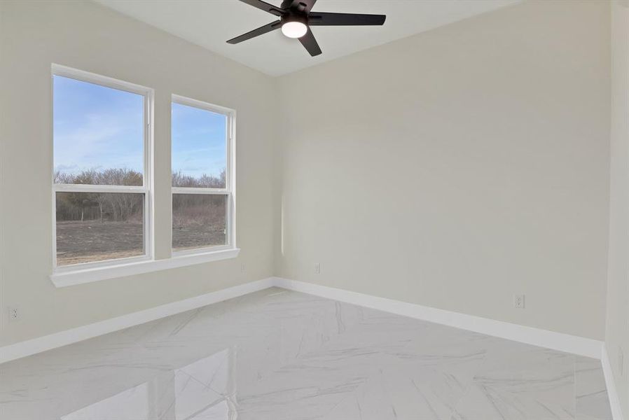 Unfurnished room featuring ceiling fan