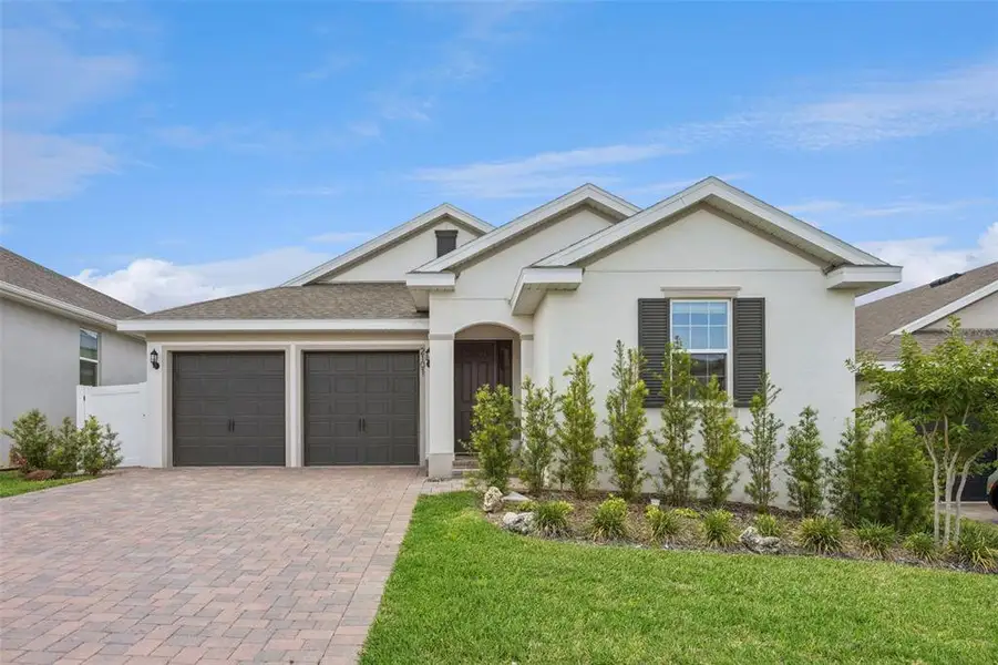 Front exterior of a new home in , Minneola, FL, highlighting curb appeal (Image 24).