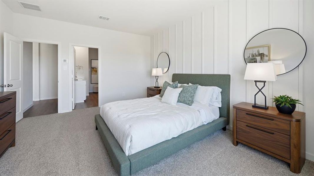 Bedroom featuring light colored carpet and baseboards Bedroom featuring light colored carpet and baseboards