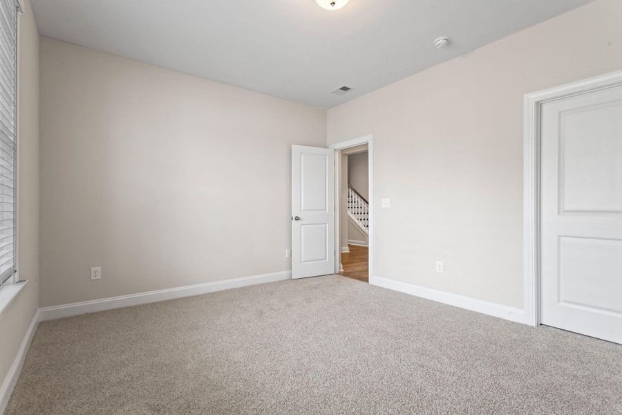 Spacious, unfurnished interior of a new home in Tidewater at Lakes of Cane Bay, Summerville (Image 24).