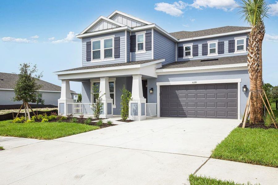Front exterior of a new home in Indigo Creek, Apollo Beach, FL, highlighting curb appeal (Image 1).