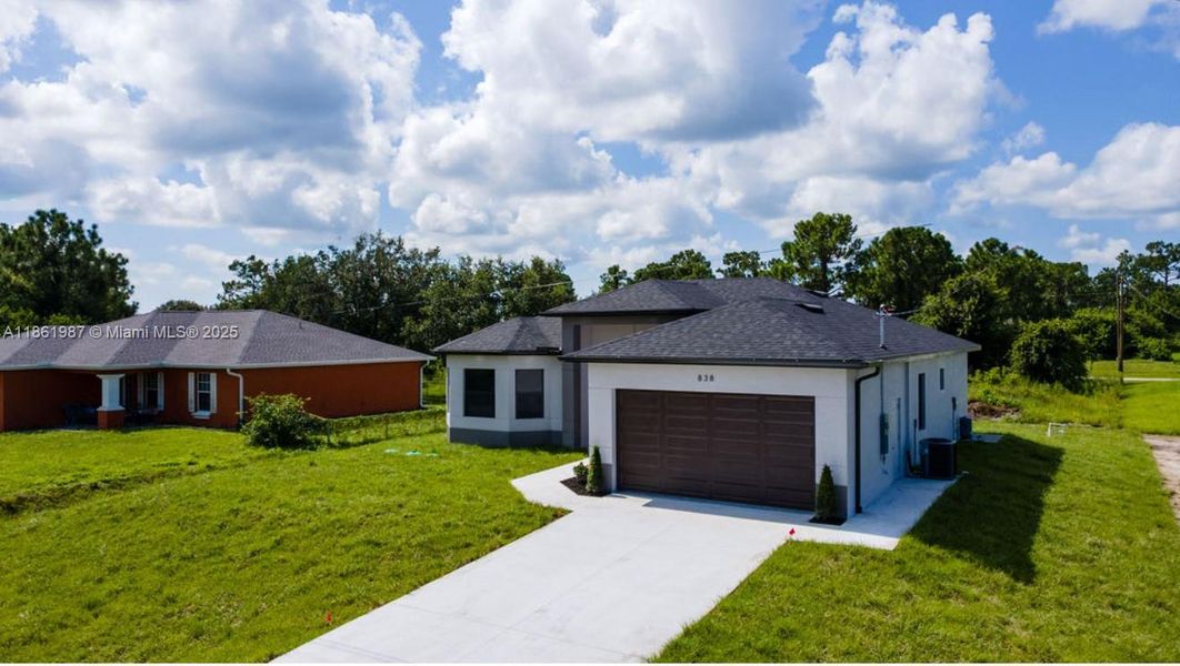 Front exterior of a new home in , Lehigh Acres, FL, highlighting curb appeal (Image 2). Front exterior of a new home in , Lehigh Acres, FL, highlighting curb appeal (Image 2).