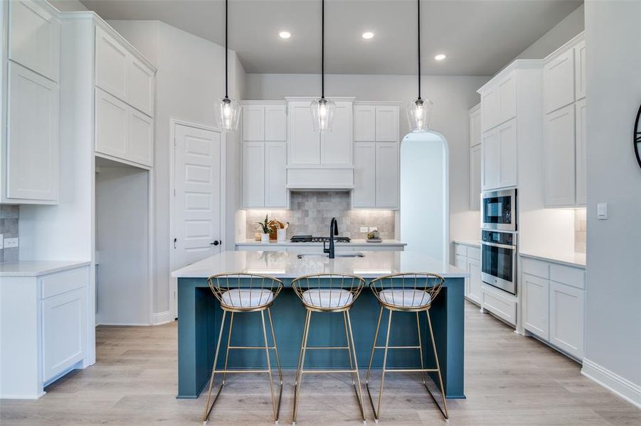 Kitchen with white cabinetry and oven