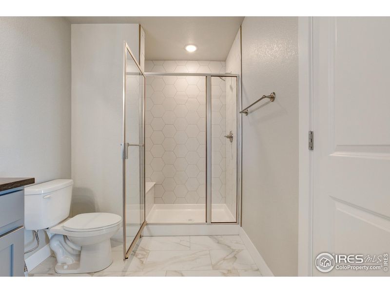 Primary Shower- Photos not of the actual unit. Finishes vary.