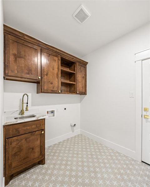 Laundry area with hookup for a washing machine, light flooring, cabinet space, and hookup for an electric dryer