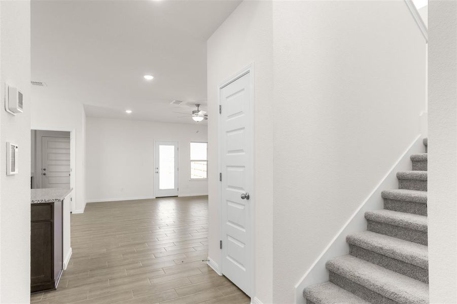 Staircase with recessed lighting, baseboards, visible vents, ceiling fan, and wood finished floors