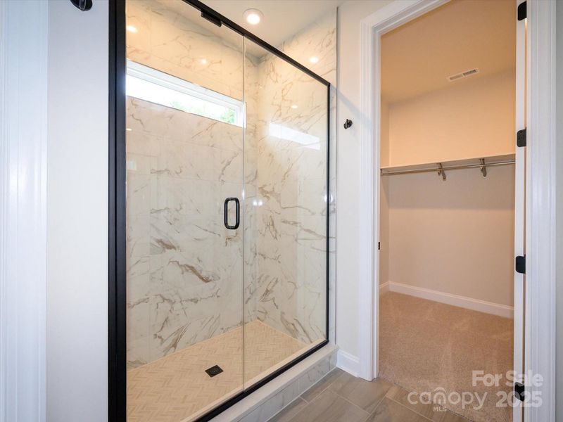 Large Walk-In Shower with Modern Marble Look Tile.