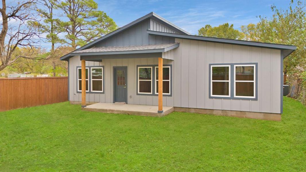 Back of property featuring a yard and central AC unit