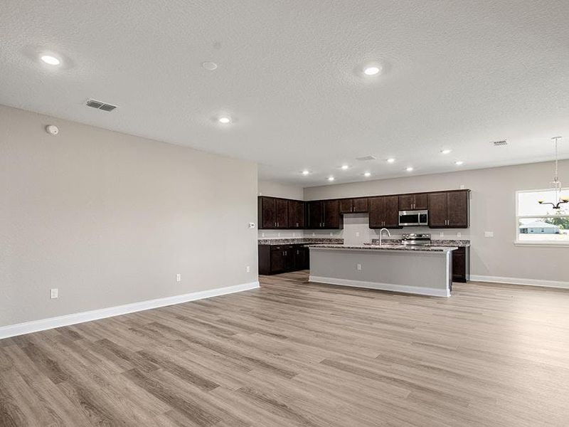 This home features a light-filled, open-concept main living area - Monroe 55+ by Highland Homes