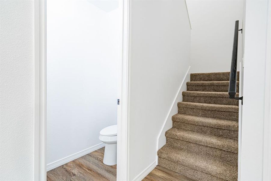 Stairway featuring light hardwood / wood-style floors