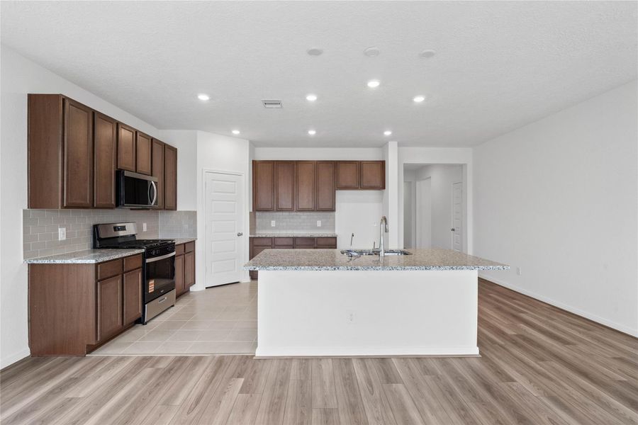 Thoughtfully designed as the true heart of the home, this kitchen serves as a warm and inviting centerpiece for both daily living and effortless entertaining Thoughtfully designed as the true heart of the home, this kitchen serves as a warm and inviting centerpiece for both daily living and effortless entertaining