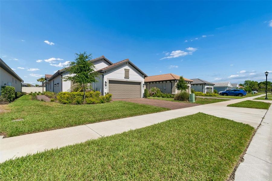 Front exterior of a new home in , Wesley Chapel, FL, highlighting curb appeal (Image 24).