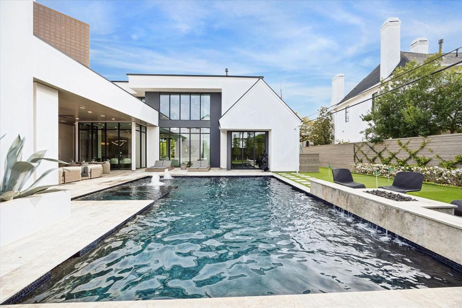 Notice the waterfall feature with a built in fire pit. Notice the waterfall feature with a built in fire pit.