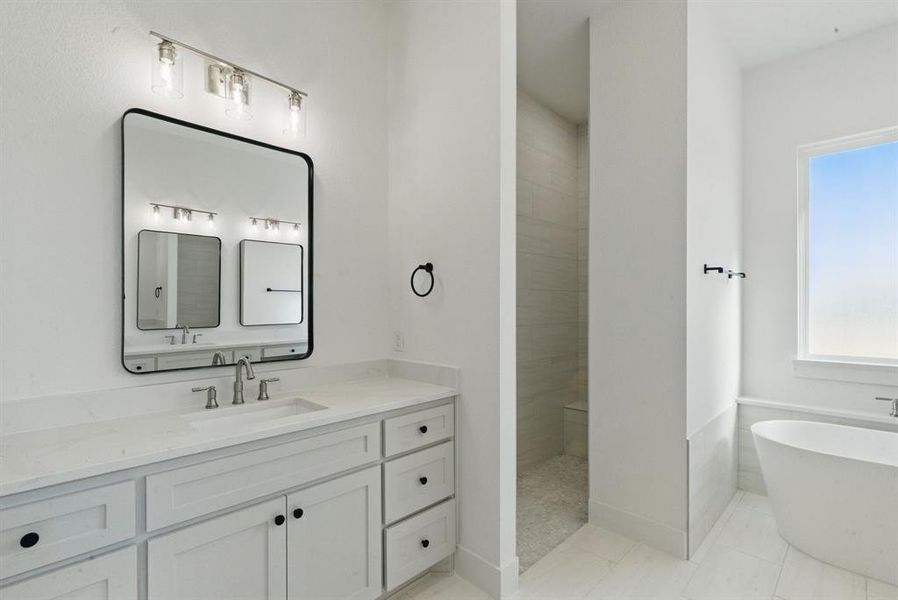Bathroom with a soaking tub, vanity, and walk in shower Bathroom with a soaking tub, vanity, and walk in shower
