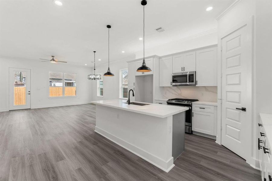 View of the living area highlighting the kitchen, dining area, and spacious living room.