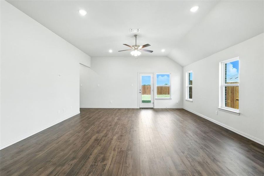 Unfurnished living room featuring recessed lighting, dark wood-style floors, lofted ceiling, and ceiling fan Unfurnished living room featuring recessed lighting, dark wood-style floors, lofted ceiling, and ceiling fan