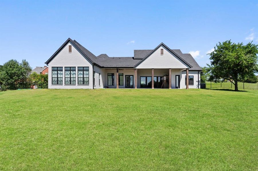 Rear view of house with a yard