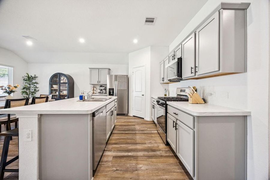 Modern kitchen featuring sleek cabinetry, stainless steel appliances, and a spacious island perfect for cooking and entertaining. Modern kitchen featuring sleek cabinetry, stainless steel appliances, and a spacious island perfect for cooking and entertaining.