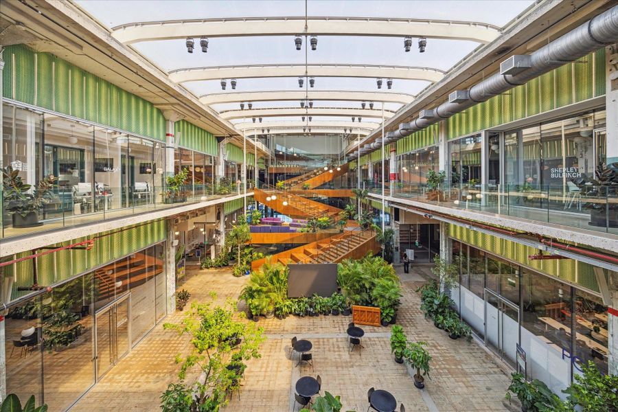 Post Houston’s interior space showcases an eclectic mix of greenery, contemporary design, and open pathways, creating an inviting atmosphere for shopping, dining, and socializing.