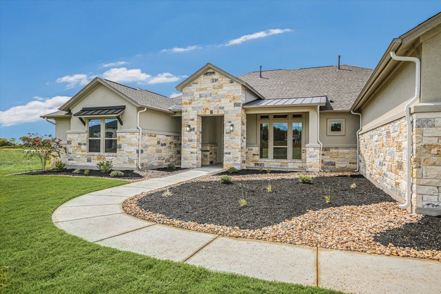 Front exterior of a new home in Scofield Farms Estates, Georgetown, TX, highlighting curb appeal (Image 22).
