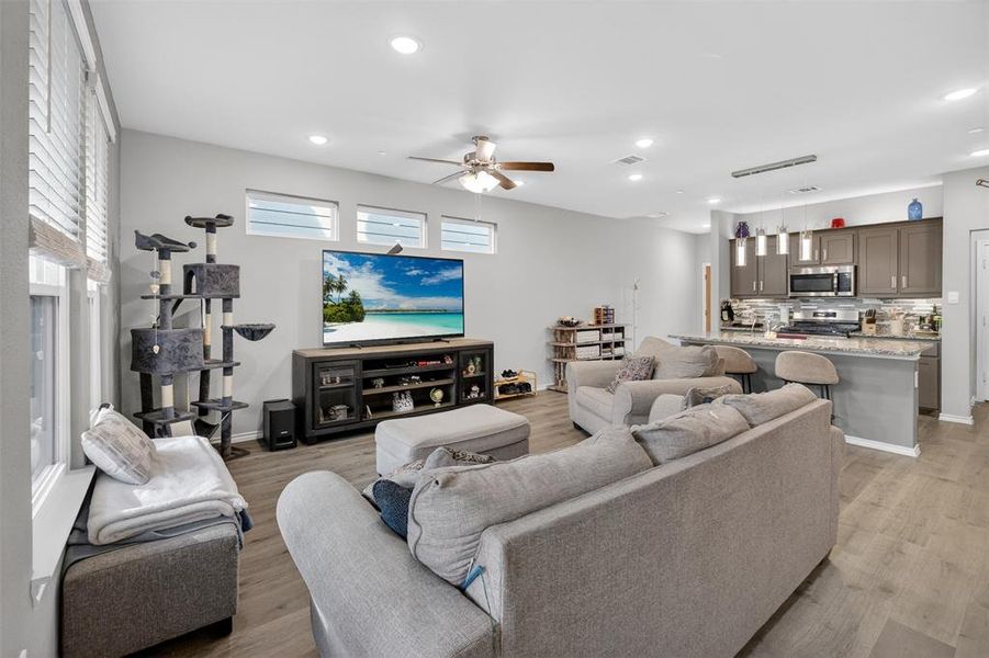 ANOTHER VIEW OF THE LIVING ROOM OPEN TO THE KITCHEN