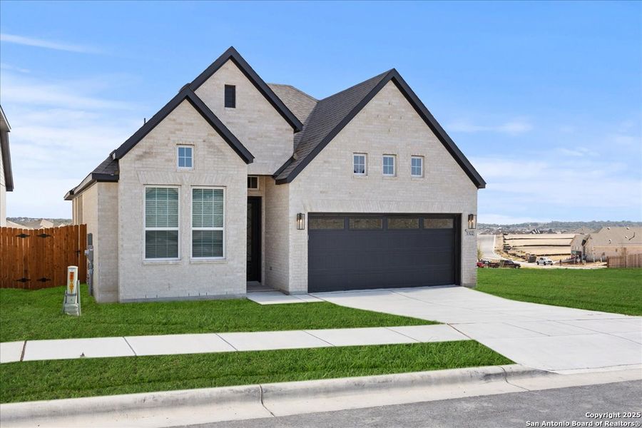Front exterior of a new home in Meyer Ranch, New Braunfels, TX, highlighting curb appeal (Image 2).