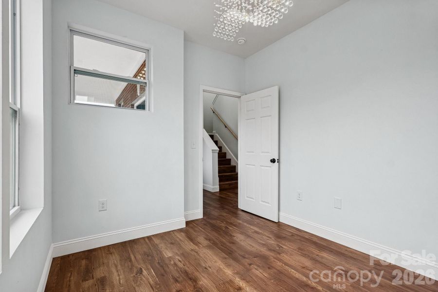 Office on the first floor with beautiful windows and elegant light fixture