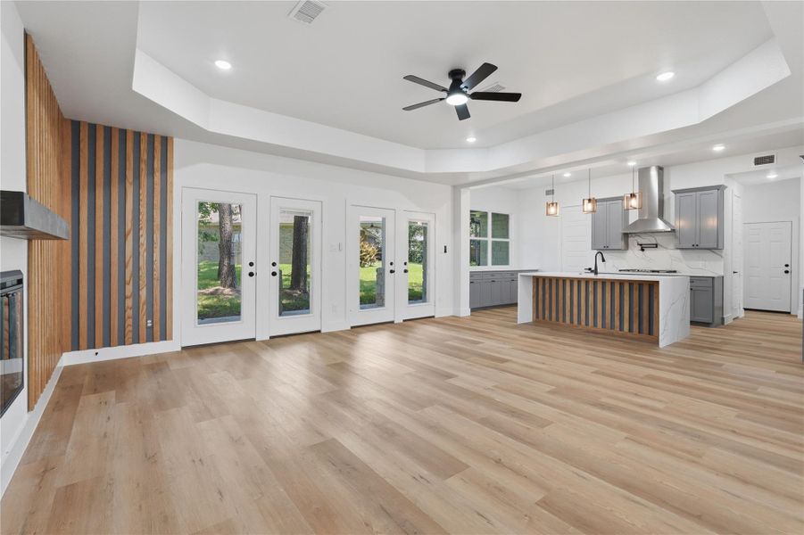 Open concept kitchen, family area with fireplace, accent wall coordinates with kitchen island, double french doors to back patio. Open concept kitchen, family area with fireplace, accent wall coordinates with kitchen island, double french doors to back patio.