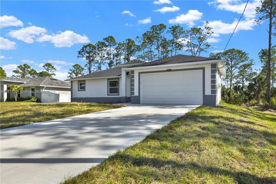 Front exterior of a new home in , Lehigh Acres, FL, highlighting curb appeal (Image 25). Front exterior of a new home in , Lehigh Acres, FL, highlighting curb appeal (Image 25).