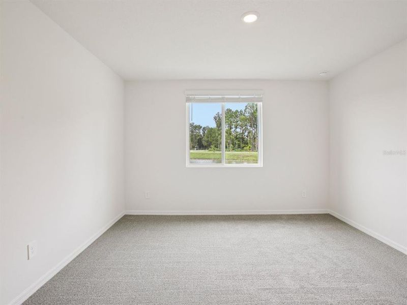 Spacious, unfurnished interior of a new home in The Grove at Stuart Crossing - Premier Series, Bartow (Image 22).