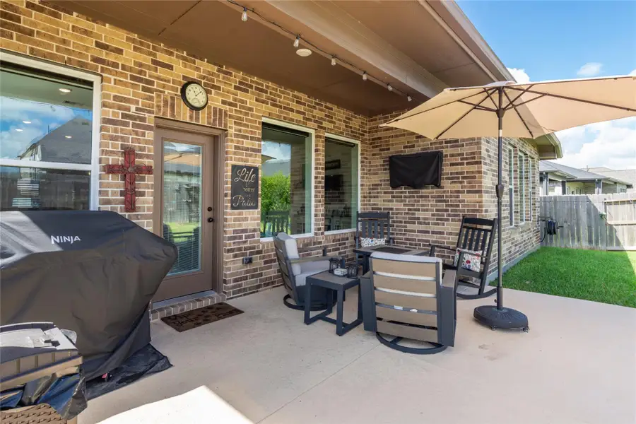 Charming backyard patio all set against a stylish brick exterior located off the open living dining/living area
