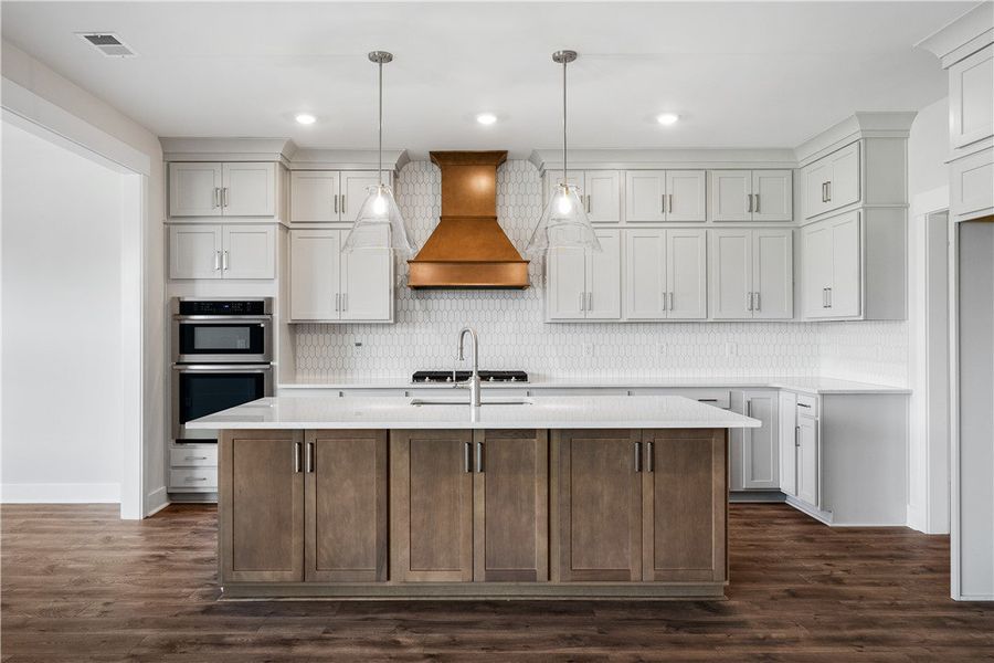 An inviting kitchen centers around a spacious isla