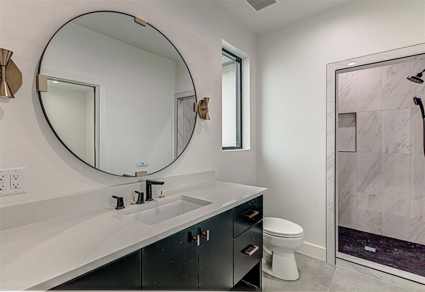 Ensuite Bathroom featuring toilet, walk in shower, visible vents, and vanity