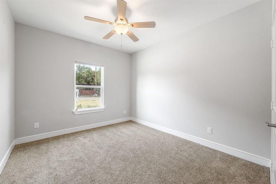 Spare room with carpet and a ceiling fan Spare room with carpet and a ceiling fan