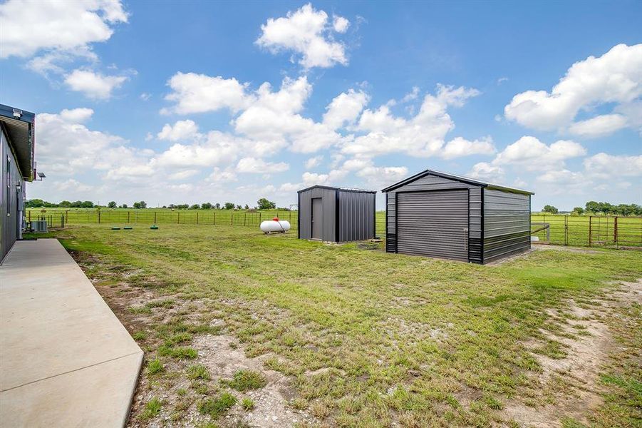 Back yard with well house and storage