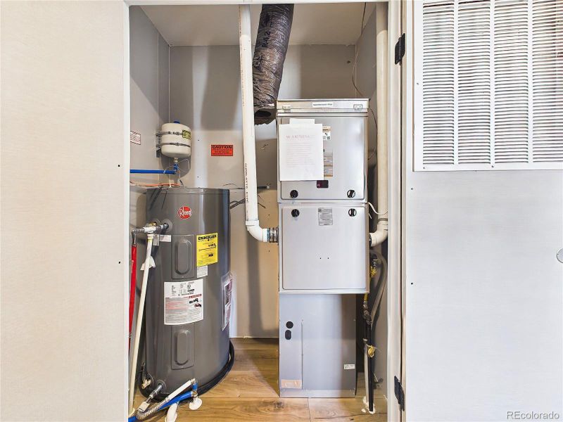 Utility Room – Mechanical room housing water heater and furnace, offering easy access for maintenance.