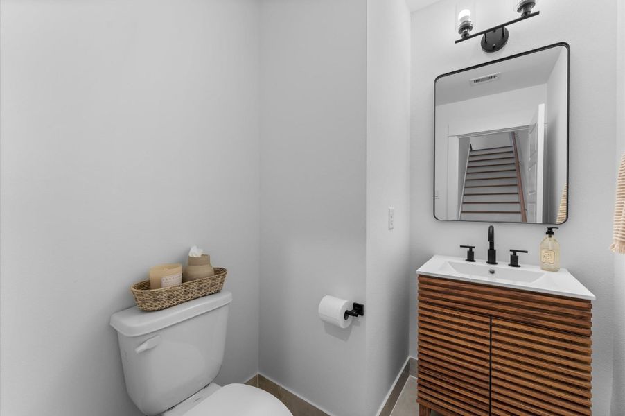 This conveniently located powder room sits between the second and third floors, offering easy access for guests without being in the main living area or too close to the bedrooms. Designed with sleek finishes and modern details, it combines style and functionality in a perfectly placed space.