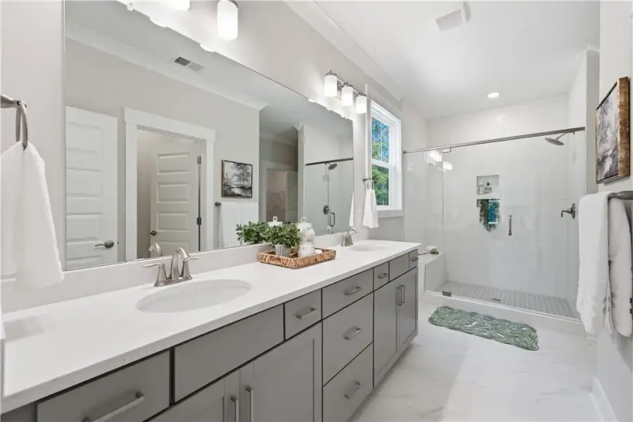 Double vanities and a glass-enclosed walk-in showe
