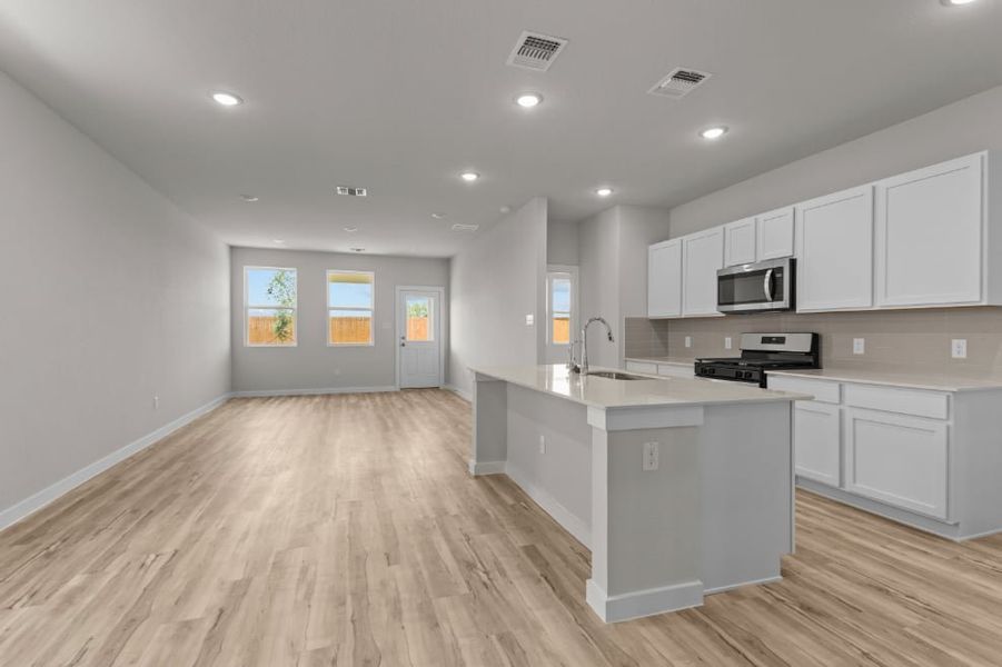A kitchen with white cabinets.
