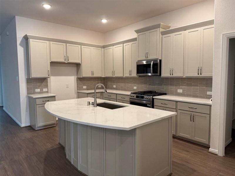 Oversized island kitchen provides additional prep space and casual seating for gatherings. Oversized island kitchen provides additional prep space and casual seating for gatherings.