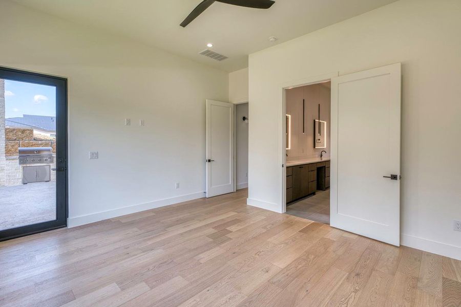Plank hardwood flooring runs throughout this bedroom featuring a direct entryway to the adjoining bath. Plank hardwood flooring runs throughout this bedroom featuring a direct entryway to the adjoining bath.
