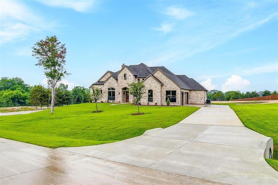 French provincial home with a front lawn