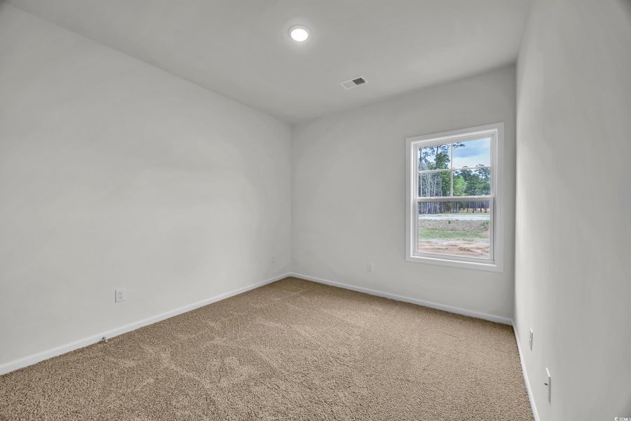 Unfurnished room featuring carpet and baseboards