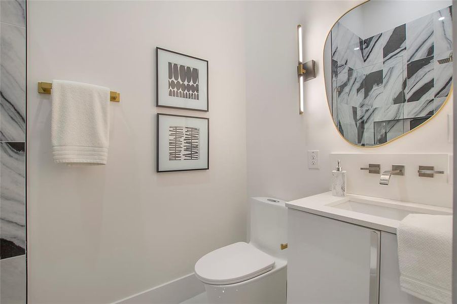 Bathroom with a shower, vanity, and toilet