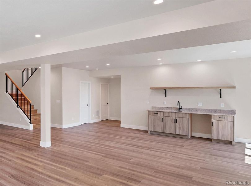 Light and bright walk-out basement, wet-bar, open base cabinet for wine or beer fridge.