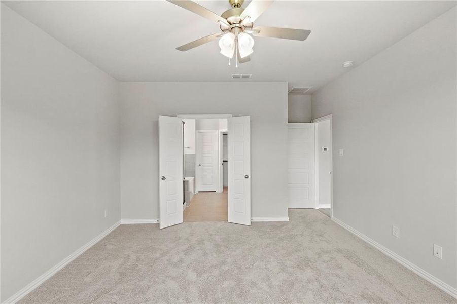 Unfurnished bedroom featuring carpet flooring and ceiling fan